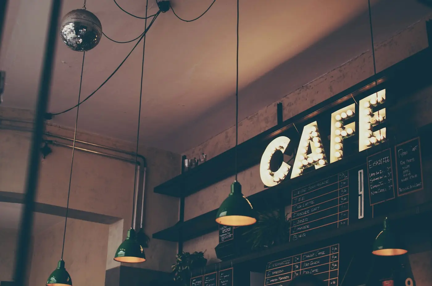 A café after closing, its sign still lit